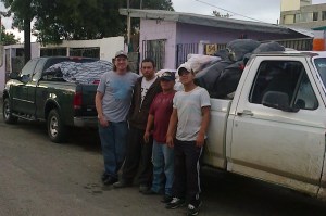 Wayne with a couple of our team members in TJ.  We just unloaded the bags you see in the white truck from the green truck.  